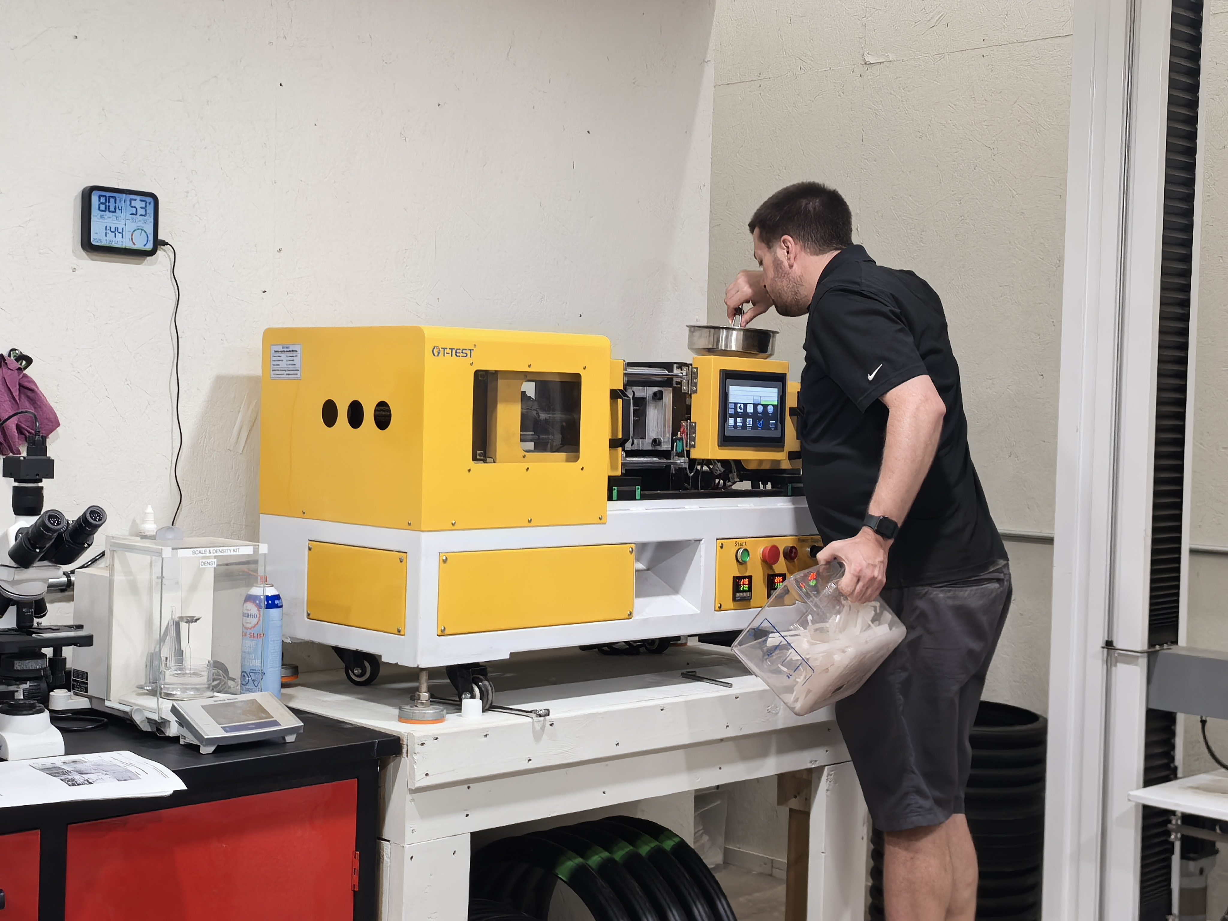 Engineer operating plastic pipe testing equipment